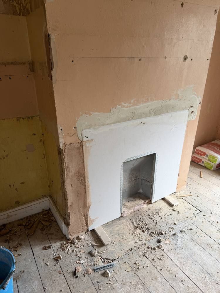 Fireplace opening boarded and beaded.